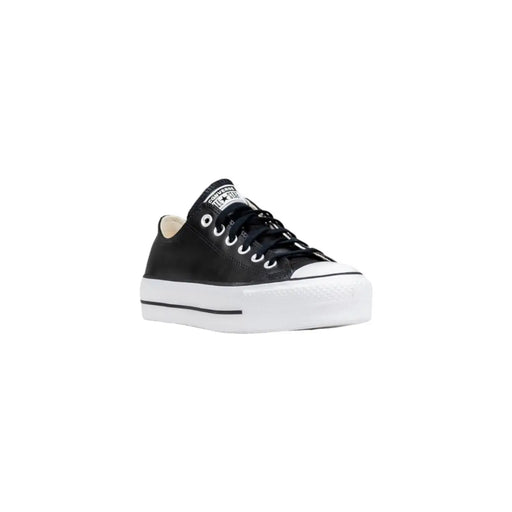 Converse Baskets à plateforme en cuir noir pour femmes, avec semelle et bout renforcé en caoutchouc blanc, au design classique.