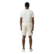 Short en coton County Of Milan pour homme, couleur crème, avec un écusson géométrique bleu vif sur la jambe gauche, vue de face