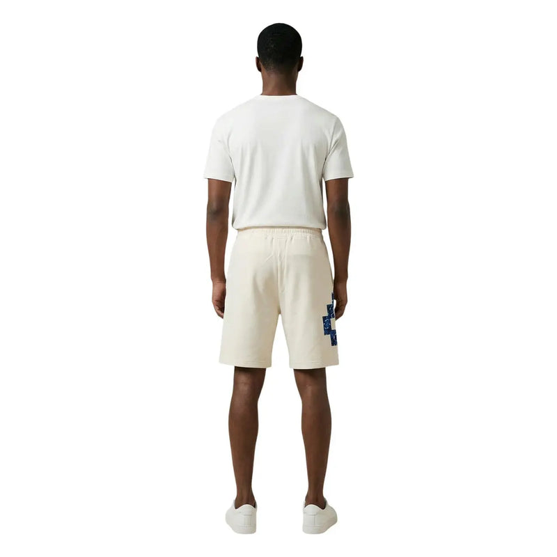 Short en coton County Of Milan pour homme, couleur crème, avec un écusson géométrique bleu vif sur la jambe gauche, vue de face