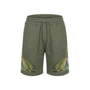 Short en coton County of Milan pour homme, vert olive, orné d'un motif d'ailes dynamique sur le bas des jambes, vue de face