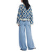 Blue and white crocheted sweater paired with wide-leg jeans for a stylish look