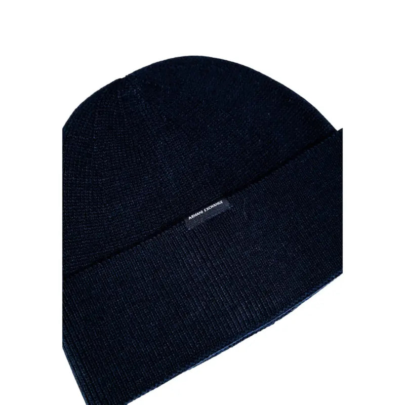 A dark blue ribbed knit beanie with a folded cuff and Armani Exchange logo tag made of soft fabric