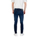 Dark blue slim-fit jeans paired with white sneakers in a men’s fashion display
