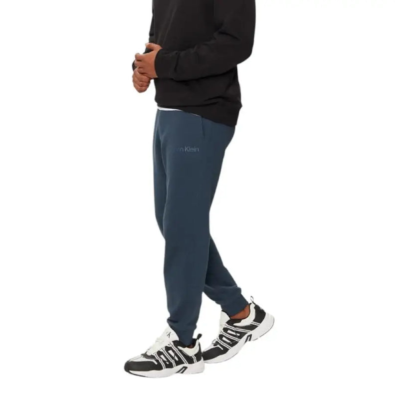 Dark blue Calvin Klein Men’s Fall Winter Jeans Trousers displayed on a neutral background