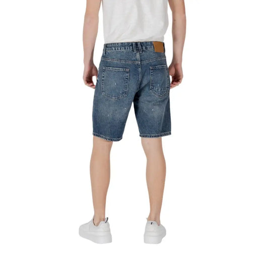 Distressed denim shorts with paint splatter detail for a trendy casual look