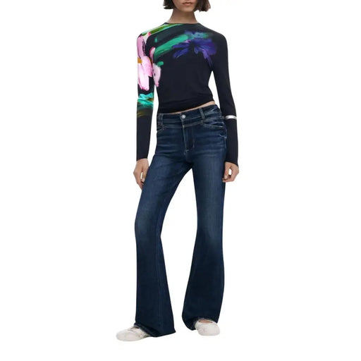 Woman wearing Desigual Black Floral Round Neck Long Knitwear with dark wash flared jeans