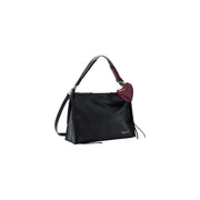 Desigual black leather handbag with shoulder strap, zip pockets, braided detailing, and burgundy heart-shaped charm
