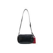 Desigual black polyester crossbody bag with glossy leather finish and red tag attached to the side