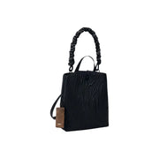 Desigual black polyurethane handbag with textured finish twisted rope handle and brown leather tag featuring zip and inside pocket