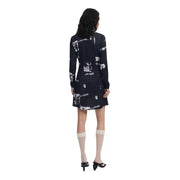 Woman wearing Desigual Black Print Round Neck Viscose Long Dress with sheer knee-high socks and black open-toed heels