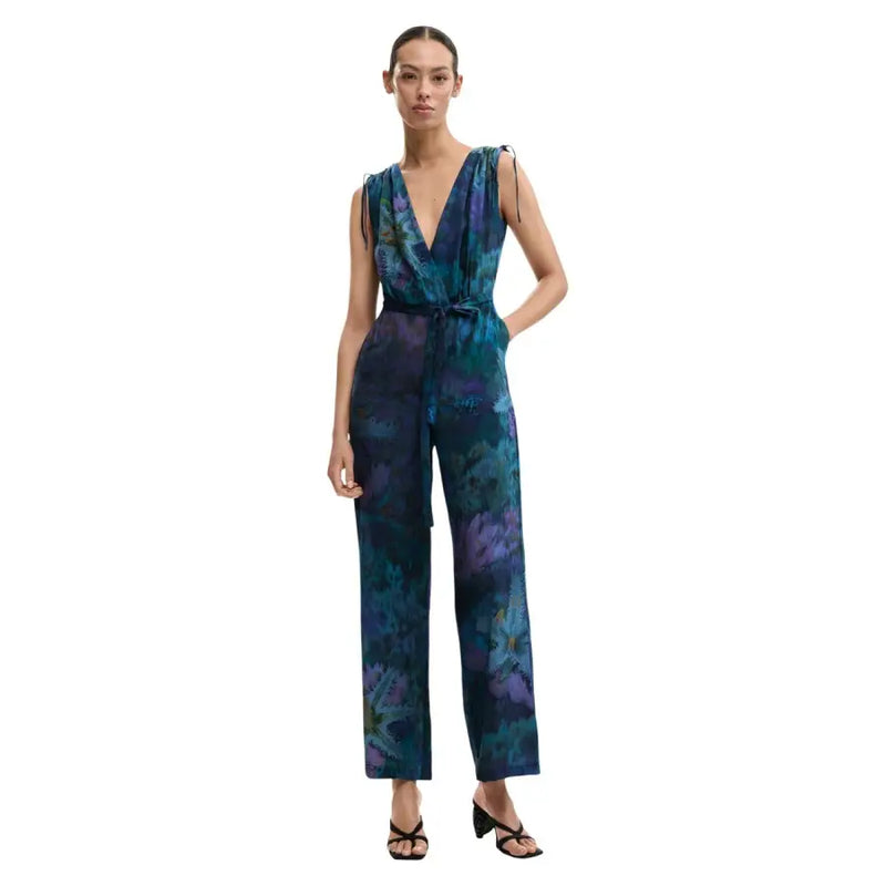 A flowing sleeveless jumpsuit by desigual in deep teal and purple abstract floral print with thin straps and self-tie belt