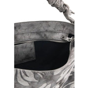 Desigual grey floral cotton handbag with gray distressed leather bucket bag style, braided handle, and tropical leaf print