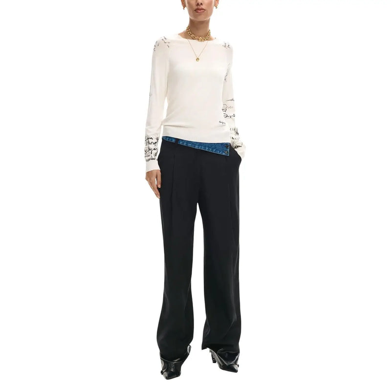 Desigual women beige long sleeve knitwear with black embroidered script on shoulders and cuffs worn over blue denim waistband
