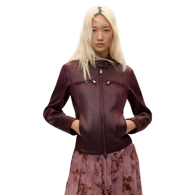 A sleek burgundy leather moto jacket with central zipper and two front pockets for stylish outerwear use