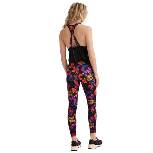 Leggings noirs à fleurs Desigual pour femme, avec un motif floral violet, orange et rose éclatant.