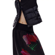 Black puffer vest with quilted panels and front zipper closure styled with desigual women black floral skirt spring summer