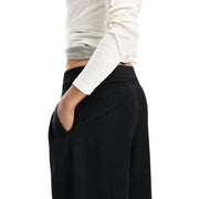 Pantalon Desigual noir pour femme, à jambes larges et fermeture éclair, taille haute, confectionné dans un mélange de polyester doux.