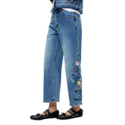 Jean en denim de coton bleu de Desigual avec broderie florale colorée le long de la jambe extérieure pour femme