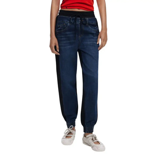 Women’s dark wash denim jogger jeans with black elastic waistband and side stripes