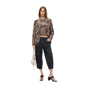 A woman wears a desigual women floral beige polyester blazer with a brown floral pattern over matching cropped tee