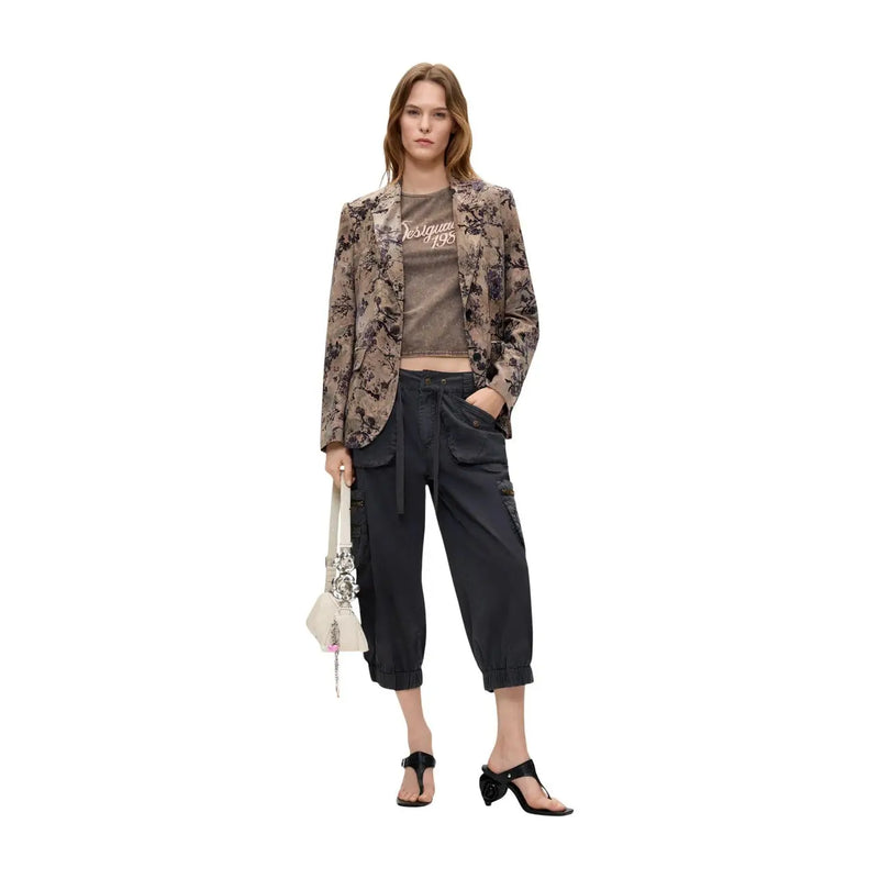 A woman wears a desigual women floral beige polyester blazer with a brown floral pattern over matching cropped tee
