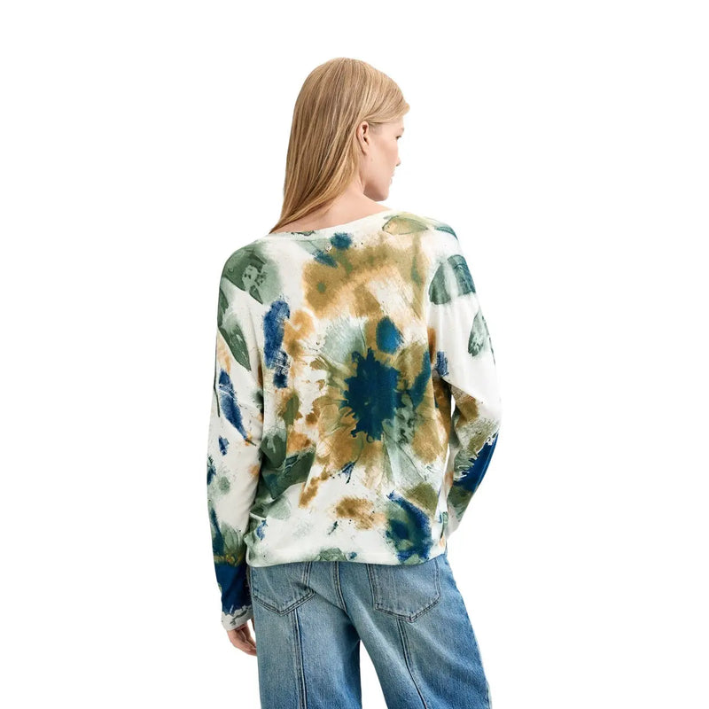 A woman wearing desigual women floral knitwear white viscose blouse with long sleeves and blue green abstract print