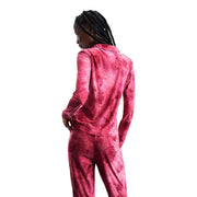 A vibrant pink satin polyester pajama set by Desigual with a subtle floral pattern and long sleeve classic shirt