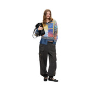 Woman wearing desigual women red knitwear wool blend sweater in colorful textured knit with denim and cargo pants
