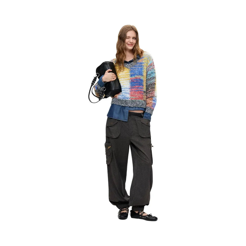 Woman wearing desigual women red knitwear wool blend sweater in colorful textured knit with denim and cargo pants