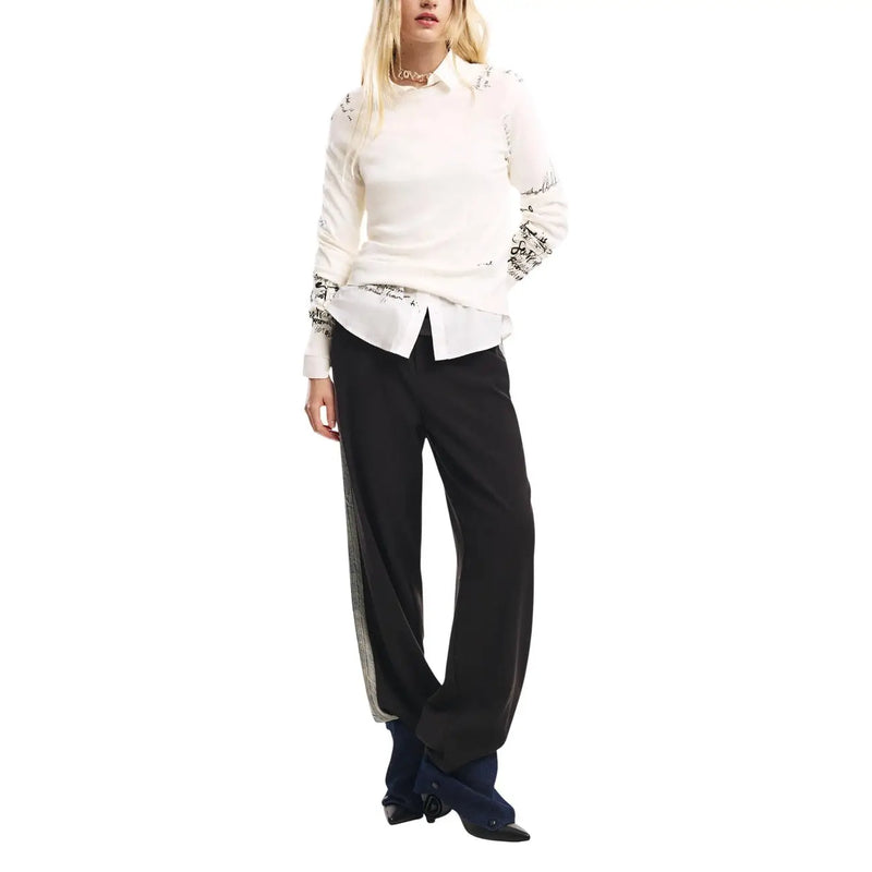 Chemisier blanc à manches longues orné de broderies noires sur les manches et les épaules, porté avec un pantalon slim noir en mélange de coton Desigual, taille 26SWPW26.