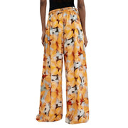 Pantalon Desigual pour femme, coupe large, en viscose orange à motif floral jaune, blanc et noir éclatant.