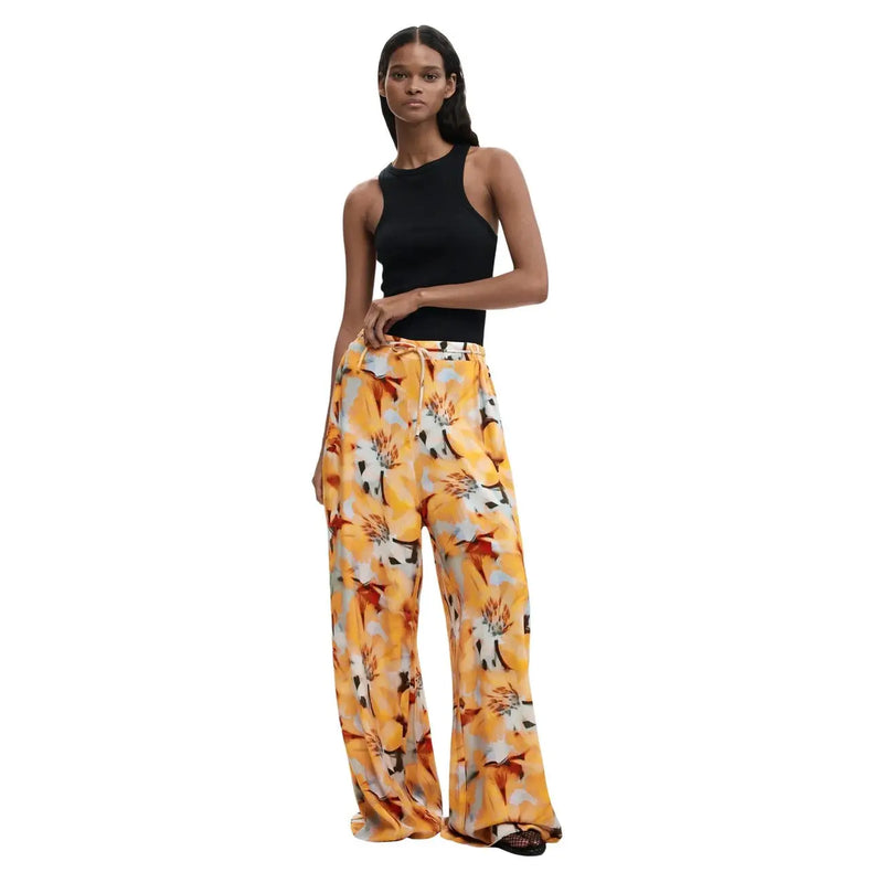 Pantalon à jambes larges en viscose légère, imprimé floral jaune vif rehaussé de touches orange et blanches, signé Desigual