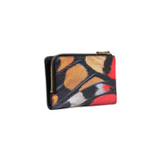 Portefeuille femme Desigual noir à fermeture éclair, petit format (16 cm), orné d'un motif abstrait à coups de pinceau orange, rouge et noir éclatants.