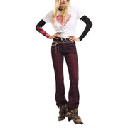 A model wearing a pair of maroon flared jeans with subtle sheen paired with a desigual women white cotton short sleeve t shirt