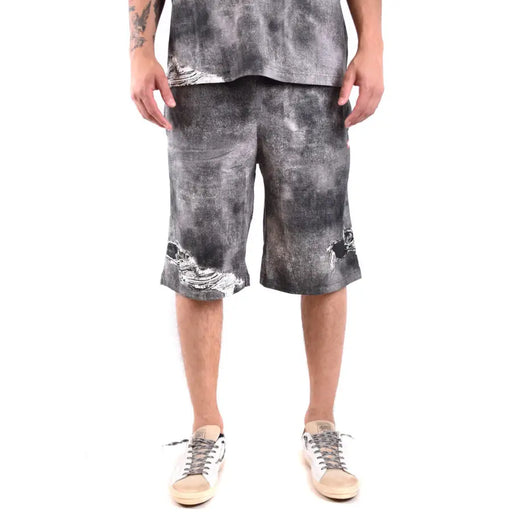 Black and white tie-dye cotton shorts with distressed edges.