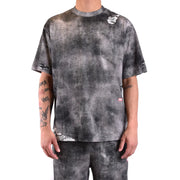 Diesel T-shirt homme en coton noir avec motif tie-dye noir et gris et détails déchirés et usés sur les manches et l'ourlet