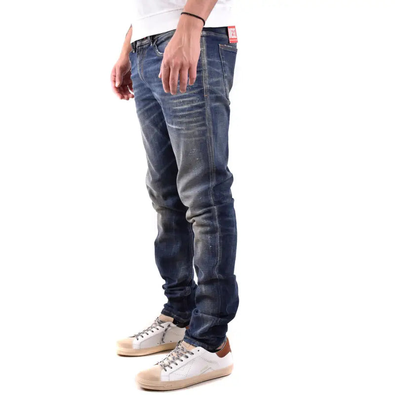 Diesel Jean homme en coton élasthanne délavé foncé, coupe slim, délavage subtil, coutures apparentes et étiquette rouge à la ceinture.