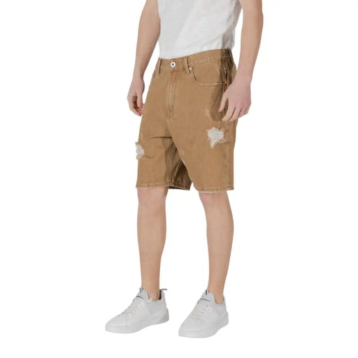 Distressed brown denim shorts displayed in a product image highlighting casual style