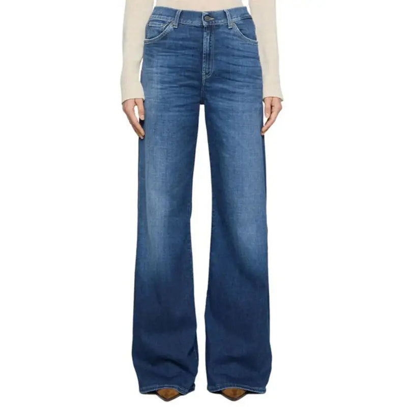 Woman wearing light-colored long-sleeve shirt and high-waisted blue wide-leg Dondup jeans