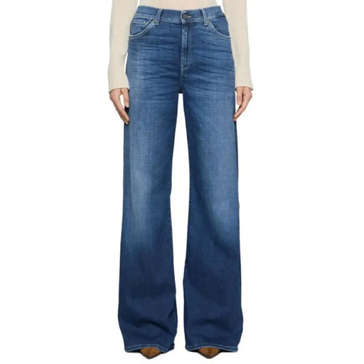 Woman wearing light-colored long-sleeve shirt and high-waisted blue wide-leg Dondup jeans