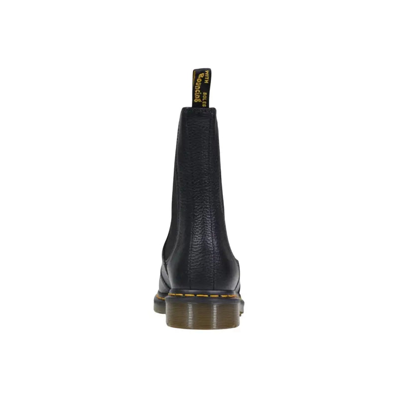 Dr Martens black leather ankle boots for women with textured finish and yellow stitching along the sole