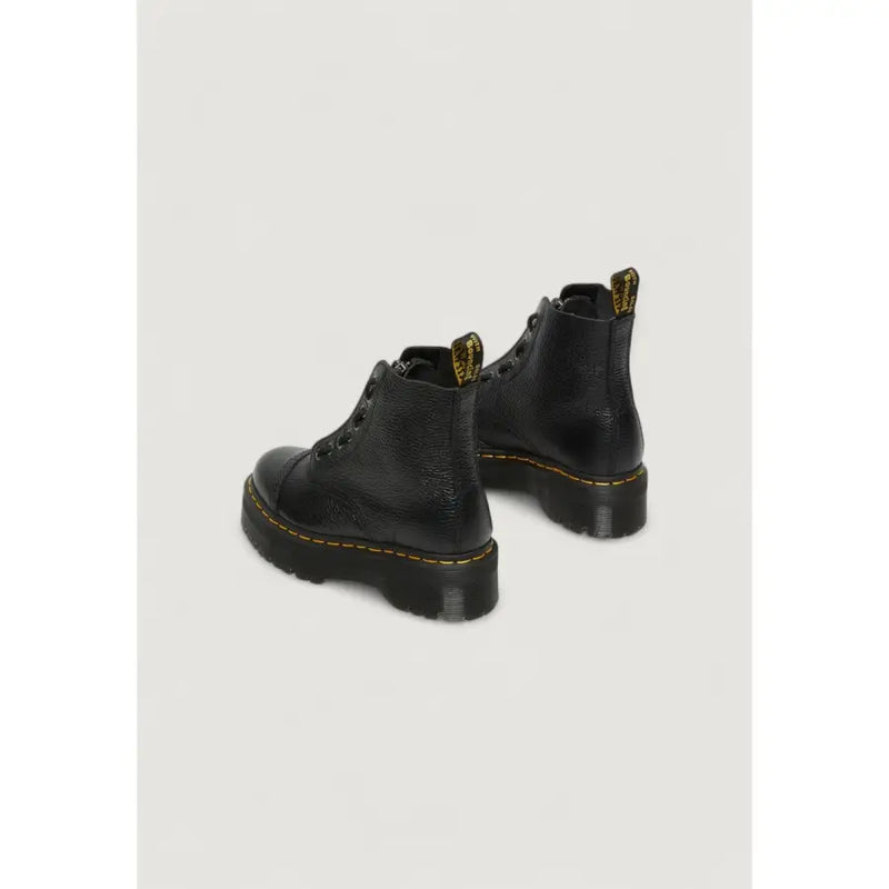 Bottines Dr. Martens en cuir noir pour femmes, vues de l'arrière, mettant en valeur la texture du cuir