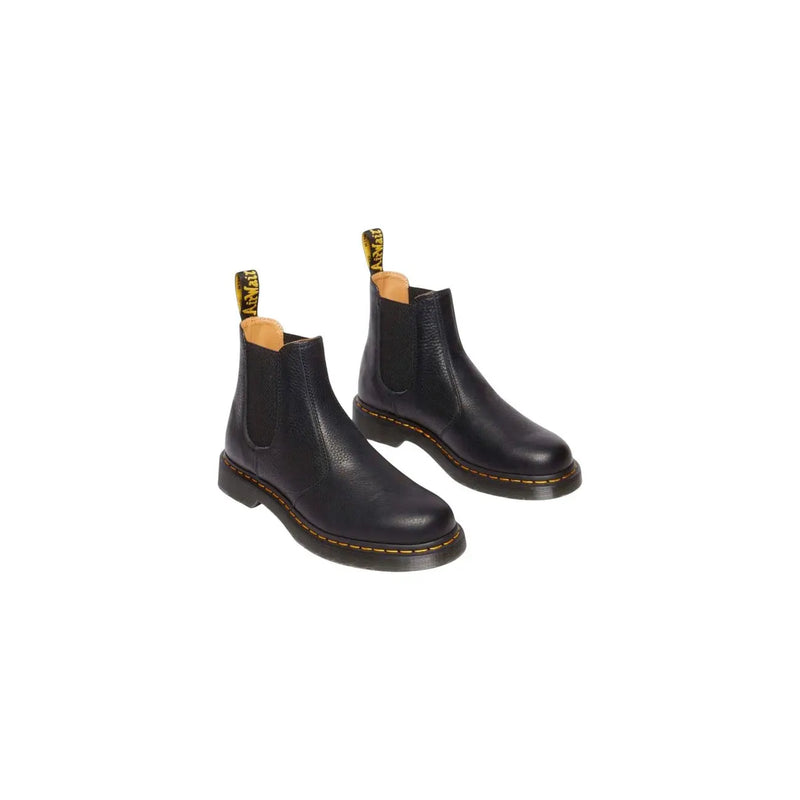 Black leather Dr Martens men ankle boots with yellow stitching and pull tabs in Chelsea boot style