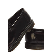 Mocassins Dr Martens Mayfair pour hommes, en cuir verni noir brillant et semelles en caoutchouc crantées distinctives.
