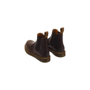 Bottes Dr. Martens pour homme en cuir marron foncé, modèle classique 2976, avec surpiqûres jaunes et design Chelsea.