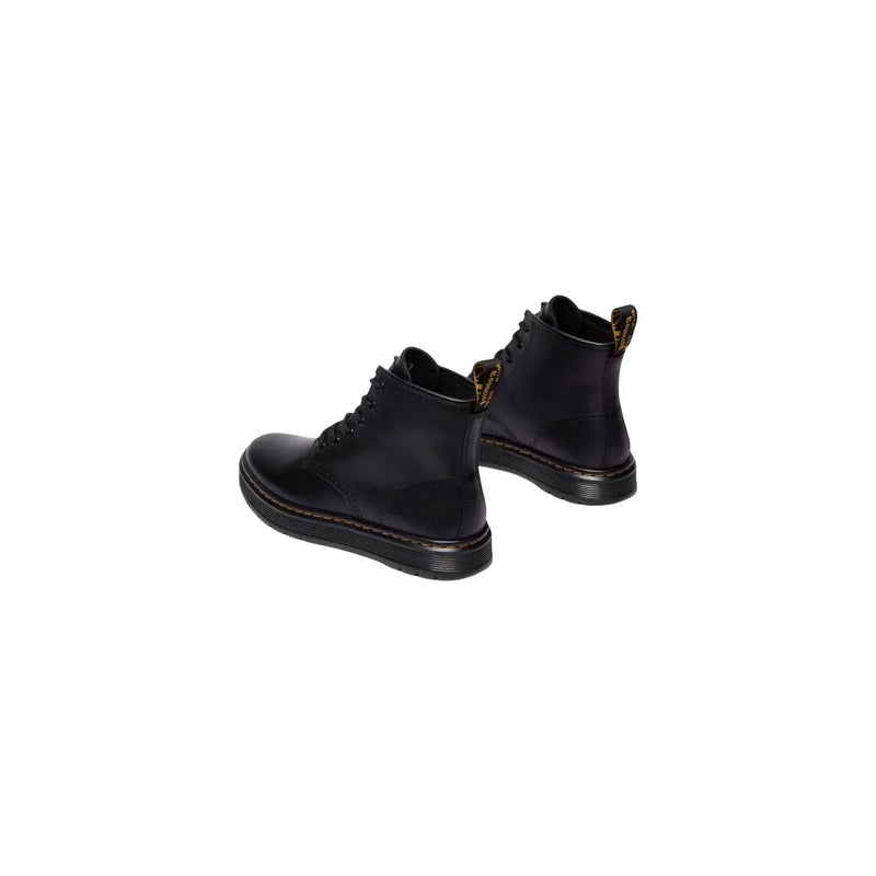 Bottines chukka Dr Martens pour homme en cuir noir, montrant l'arrière avec un cuir lisse et une semelle robuste.