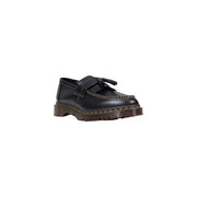Mocassin Dr Martens pour homme en cuir noir, à enfiler, avec pompons, surpiqûres jaunes et semelle épaisse marron.
