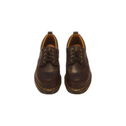 Bottes Dr. Martens pour homme, en cuir marron foncé, à enfiler, avec une finition lisse et un design discret.