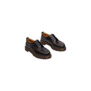 Mocassins Dr. Martens Lowell pour homme en cuir noir, vus de l'arrière, mettant en valeur leur design élégant.