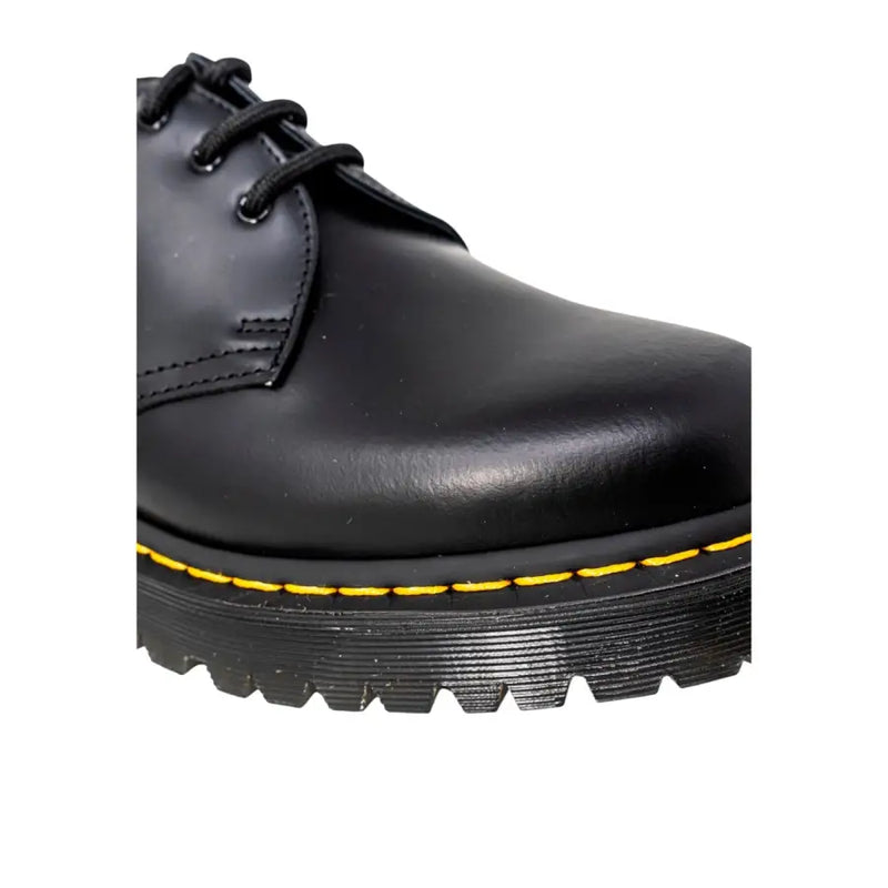 Dr martens men’s black leather lace-up shoes showing the back side with sturdy heel and classic design